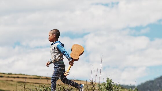 Ein kleiner Junge mit Ukulele | © unsplash