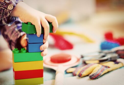 Kinderhände bauen einen Turm mit Bausteinen. | © pixabay.com
