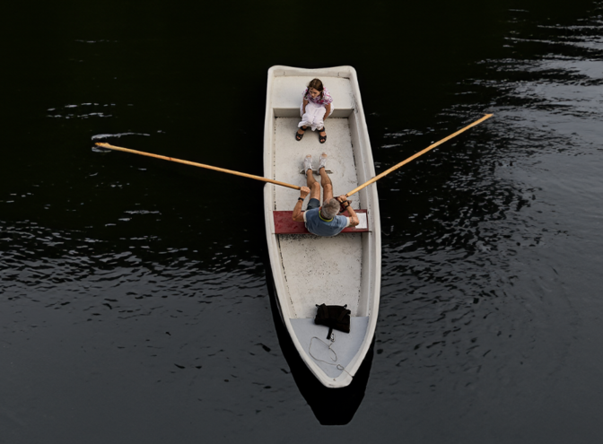 Ein Schiff, auf dem ein Mann und ein kleines Mädchen sitzen, das Wasser ist dunkel. | © pexels